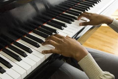 Playing piano  Copyright: MichèlexConstantini B64998706