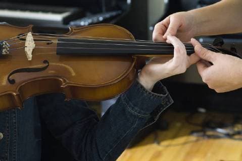 Learning to play the violin  Copyright: MichèlexConstantini B66697906