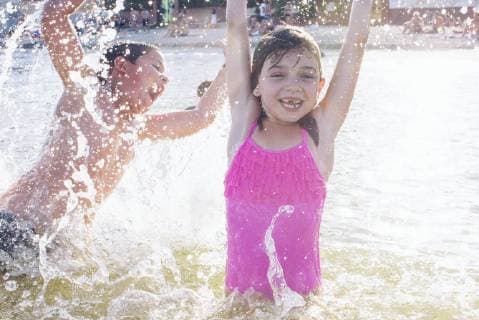 Siblings playing in water  Copyright: Anne-SophiexBost B78912631