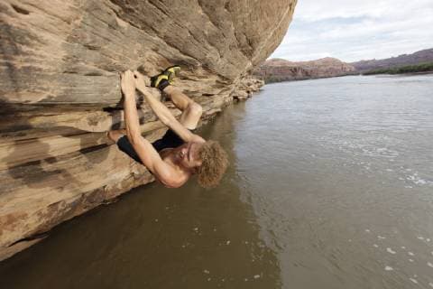 Andy Lewis bouldering over the Colorado river at Gold Bar just outside Moab, Utah, Moab Utah United States Copyright: JaredxAlden 4517100016