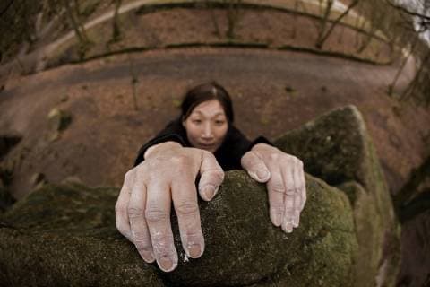 close up of hands on top of a bouldering problem at the Peak district UK, Stanage Peak District United Kingdom model released Symbolfoto Copyright: HennxPhotography 5048000010