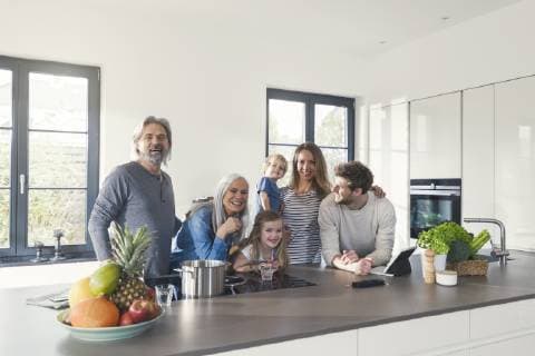 Happy family with grandparents and children standing in the kitchen model released Symbolfoto property released SBOF00512