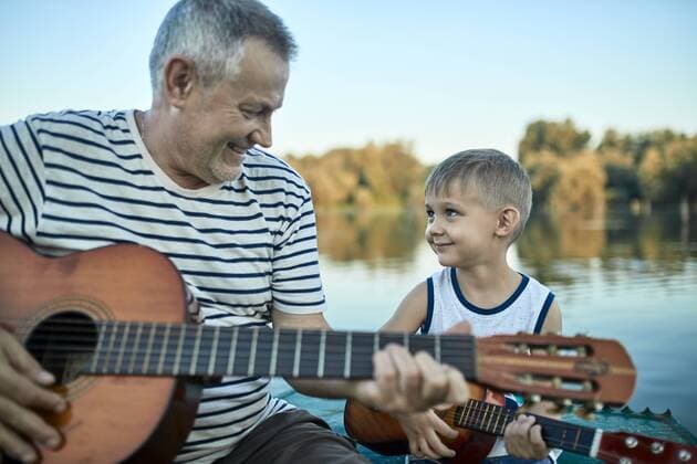 Grandfather teaching grandson playing guitar model released Symbolfoto  ZEDF01498