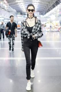 Chinese model Xi Mengyao, better known as Ming Xi, arrives at the Beijing Capital International Airport before flying to France for the Paris Fashion Week Spring Summer 2019 in Beijing, China, 26 September 2018. Ming Xi flashes stunning slim figure in trendy outfit at Beijing airport ahead of Paris Fashion Week  pbu874356_07