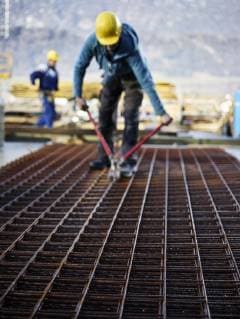 Construction worker cutting iron with plier model released Symbolfoto property released  CVF00986