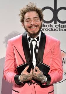 Rapper Post Malone appears backstage with his award for Favorite Male Artist - Pop Rock, during the 46th annual American Music Awards at the Microsoft Theater in Los Angeles on October 9, 2018.  LAP20181009545 JIMxRUYMEN