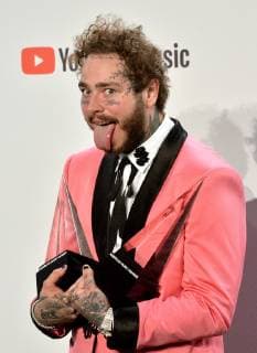 Rapper Post Malone appears backstage with his award for Favorite Male Artist - Pop Rock, during the 46th annual American Music Awards at the Microsoft Theater in Los Angeles on October 9, 2018.  LAP20181009551 JIMxRUYMEN
