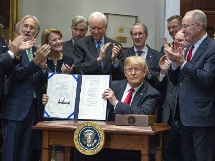 October 11, 2018 - Washington, District of Columbia, U.S. - United States President Donald J. Trump holds up the document after signing H.R. 1551, the Orrin G. Hatch-Bob Goodlatte Music Modernization Act in the Roosevelt Room of the White House in Washington, DC on Thursday, October 11, 2018. Pictured from left to right behind the President: President and CEO of The Recording Academy Neil Portnow; US Senator Shelley Moore Capito (Republican of West Virginia); US Senator Sheldon Whitehouse (Democrat of Rhode Island); US Senator Orrin Hatch (Republican of Utah); US Representative Bob Goodlatte (Republican of Virginia); US Senator Chris Coons (Democrat of Delaware); and US Senator Lamar Alexander (Republican of Tennessee) Washington U.S. - ZUMAs152 20181011_zaa_s152_071 Copyright: xRonxSachsx
