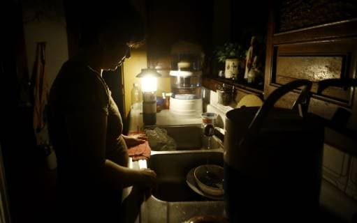 October 15, 2018 - Valencia, Carabobo, Venezuela - October 15, 2018. A woman washes dishes after dinner, in the middle of the blackout. Without electricity, half of Venezuela suffered an electrical blackout that affected fourteen states of the western central region of the twenty-four entities that make up the country. The capital Caracas was also affected in large part, the situation was generated at 8.00pm local time, while President Nicol¡s Maduro addressed the nation on national radio and television. The photos correspond to the city of Valencia, Carabobo state. Photo: Juan Carlos Hern¡ndez Valencia Venezuela - ZUMAhe3_ 20181015_zbp_he3_004 Copyright: xJuanxCarlosxHernandezx