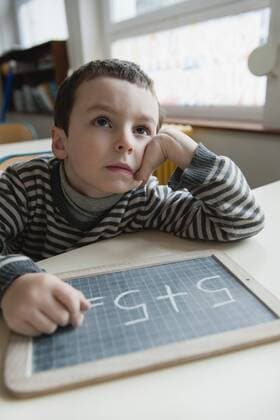 Boy solving math problem  Copyright: JérômexGorin B65125425