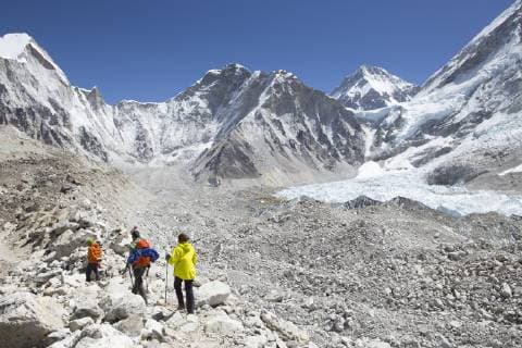 Three hikers are arriving in Everest Base Camp after a trekking through the Nepalese Khumbu valley. The trek to Everest Base Camp (EBC) is possibly the most dramatic and picturesque in the Nepalese Himalaya. Not only will you stand face to face with Mount Everest, Sagarmatha in Nepali language, at 8,848 m (29,029 ft), but you will be following in the footsteps of great mountaineers like Edmund Hillary and Tenzing Norgay. The trek is scenic and offers ever-changing Himalayan scenery through forests, hills and quaint villages. A great sense of anticipation builds as you trek up the Khumbu Valley, passing through intriguing Sherpa villages, Tibetan monasteries, all towered over by some of highest and most stunningly beautiful mountains of the world., Lukla Khumbu Nepal BOME001506 Copyright: MennoxBoermans BOME001506
