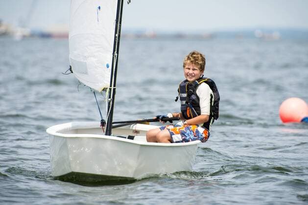 Smiling Teenage Boy Enjoying On Narragansett Bay In Summer Junior Sailing Program, North Kingstown Rhode Island United States model released Symbolfoto Copyright: CatexBrown BRCA000143