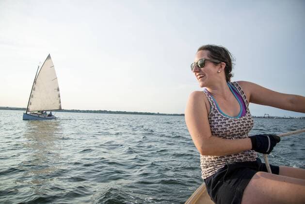 Smiling woman enjoying sailing on Narragansett Bay, North Kingstown Rhode Island United States model released Symbolfoto Copyright: CatexBrown BRCA001237