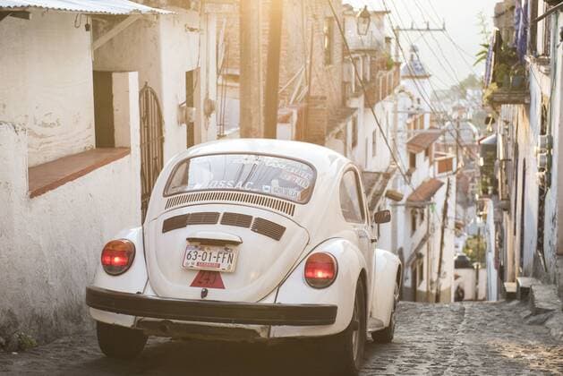 A classic Volkswagen Beetle climbs down from a hill in the cobbled streets of Taxco, Guerrero, Mexico., Taxco Guerrero Mexico Copyright: MarcosxFerro FEMR000833