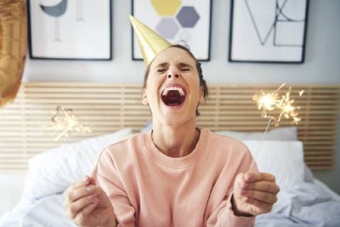 Cheerful woman during her birthday with sparklers model released Symbolfoto property released  ABIF00978