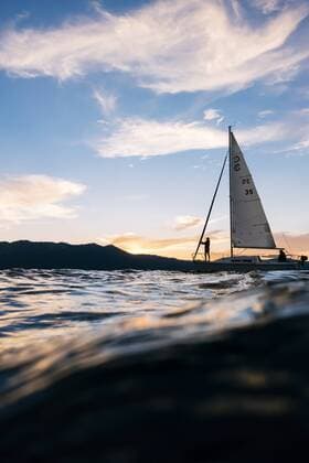 The small yacht Freshwater Cowboy is sailing on Lake Tahoe at sunset., Lake Tahoe California USA model released Symbolfoto property released Copyright: AndrewxPeacock PEAN000050