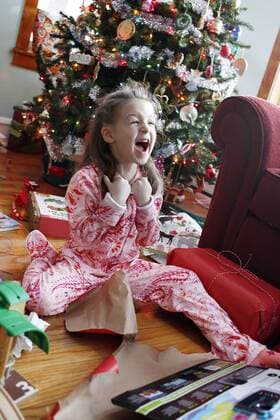 Happy girl after opening Christmas present, Oak Park IL United States model released Symbolfoto Copyright: BethxRooney ROBE000763