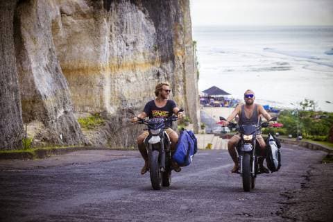 Man on motorcycle with surfboard at Bali., Pandawa beach Bali Indonesia model released Symbolfoto Copyright: KonstantinxTrubavin TRKO001322