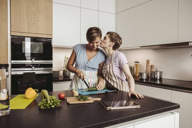 Happy lesbian couple in kitchen cooking together model released Symbolfoto property released  MFF04423