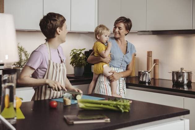 Happy lesbian couple and their child in kitchen model released Symbolfoto property released  MFF04424
