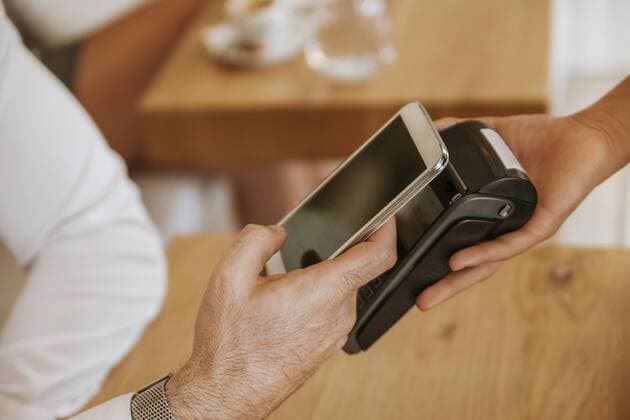 Contactless payment with smartphone in cafe model released Symbolfoto property released  ZEDF00879