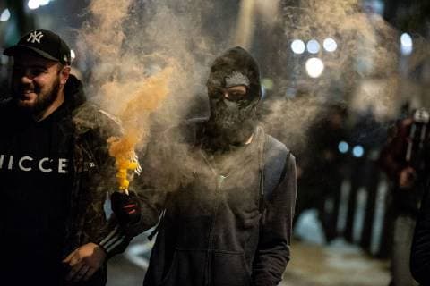 November 5, 2018 - London, London, UK - London, UK. A demonstrator lights a flare as he takes part in the Million Mask March, an anti-capitalist protest organised by Anonymous UK. The march takes place on bonfire night, the anniversary of Guy Fawkes plot to blow up the Houses of Parliament with gunpowder. London UK - ZUMAl94_ 20181105_zaf_l94_069 Copyright: xTomxNicholsonx