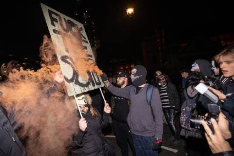 November 5, 2018 - London, London, UK - London, UK. A demonstrator lights a flare as he takes part in the Million Mask March, an anti-capitalist protest organised by Anonymous UK. The march takes place on bonfire night, the anniversary of Guy Fawkes plot to blow up the Houses of Parliament with gunpowder. London UK - ZUMAl94_ 20181105_zaf_l94_068 Copyright: xTomxNicholsonx