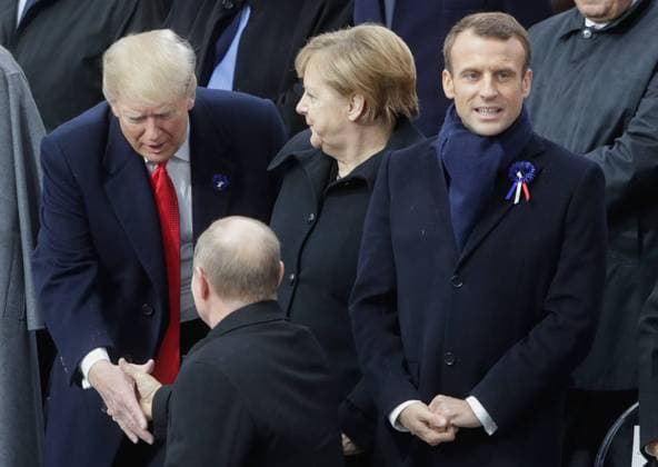 PARIS, FRANCE - NOVEMBER 11, 2018: US President Donald Trump, Germany s Chancellor Angela Merkel, France s President Emmanuel Macron (L-R back), and Russia s President Vladimir Putin (front) attend a ceremony to celebrate the 100th anniversary of the end of the First World War at the Triumphal Arch on the Elysian Fields in Paris. Mikhail Metzel TASS  TS09704C