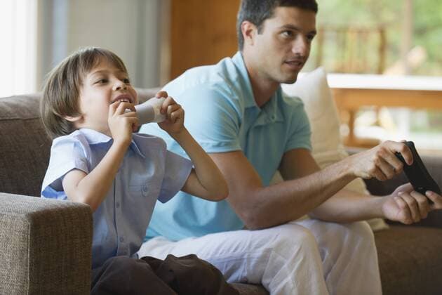 Father and son playing video game together  Copyright: LaurencexMouton B72753817