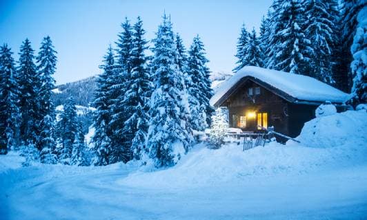 Austria, Altenmarkt-Zauchensee, sledges, snowman and Christmas tree at illuminated wooden house in snow at dusk property released  HHF05513