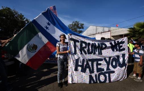 November 25, 2018 - Tijuana, Mexico - Crossing the almost dry Tijuana river. Migrant caravan from camp Centro Deportivo Benito Juarez marches to the Tijuana-San Diego border on November 25, 2018. They were met by a line of Mexican police in riot gear at the bridge but managed to run past them, climbing up steep walls, crossing the Rio Tijuana and difficult terrain, reaching the border but were met at times by tear gas from U.S. agents when they tried to climb over fence and were pleading to be let in. Eventually Mexican police moved the crowd, including many women and children back to the shelter. Tijuana Mexico - ZUMAg208 20181125_zap_g208_003 Copyright: xCarolxGuzyx