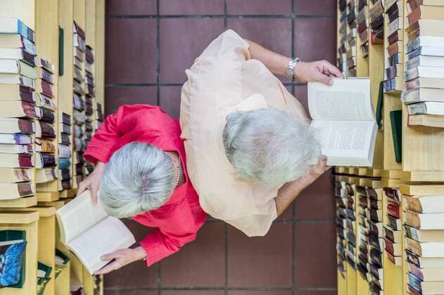 Two users reading books back to back in a city library, top view model released Symbolfoto property released  FRF00575