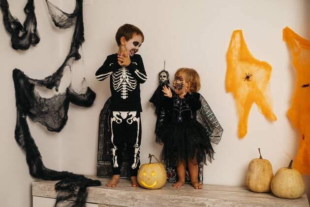 Boy and his little sister wearing fancy dresses at Halloween model released Symbolfoto property released  JRFF01885