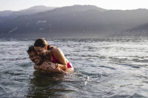 Happy playful young couple in a lake model released Symbolfoto  MRAF00289