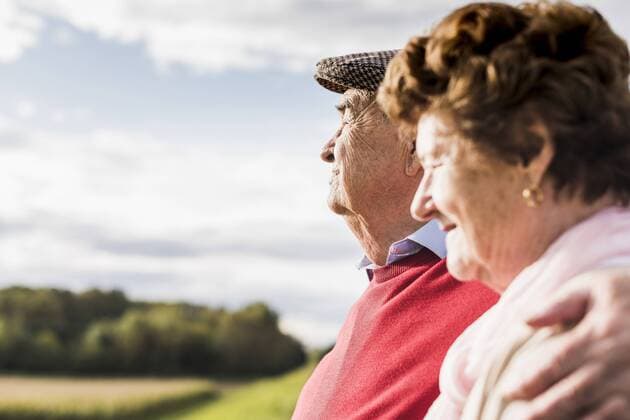 Senior couple embracing in rural landscape model released Symbolfoto  UUF12035