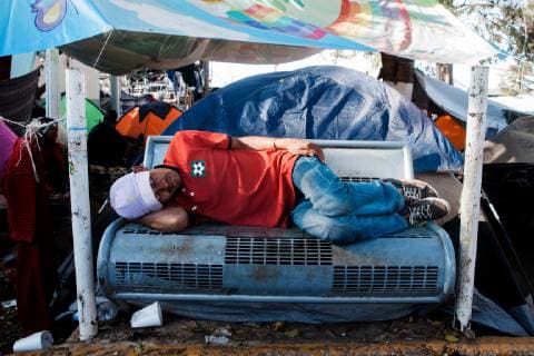 A man who has traveled with the migrant caravan sleeps on a bench in the Benito Juarez migrant shelter in Tijuana, Mexico on November 27, 2018. At present, 5,800 migrants and asylum seekers are staying at the shelter waiting for a chance to enter the U.S.  TIJ20181127205 ARIANAxDREHSLER
