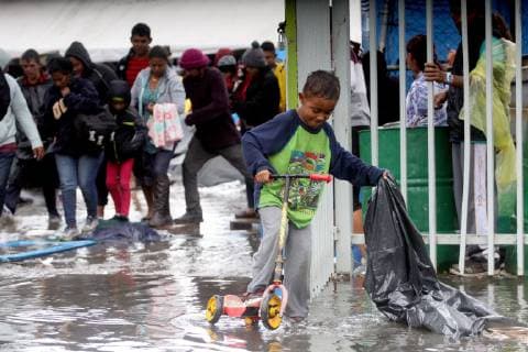 A child plays in the rain after the shelter where the migrant caravan staying got flooded due to the heavy rains, in Tijuana, Mexico, 29 November 2018. The situation of the Central Americans stuck at the Tijuana border entered a new stage of waiting as the new government of Andres Manuel Lopez Obrador will be made official next Saturday. Central Americans await AMLO s oath of office in Mexico !ACHTUNG: NUR REDAKTIONELLE NUTZUNG!  Copyright: xAlejandroxZepedax AME2637 20181130-636791400057773531