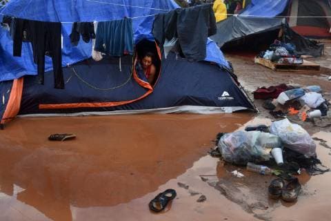November 29, 2018 - Tijuana, Mexico - People navigate severe flooding at the migrant caravan camp Centro Deportivo Benito Juarez on November 29, 2018. It is being called a humanitarian crisis. IMELDA LIMA LOPEZ and her twins look at dirty water at their tent. SAIRA MAVEC MEZA, 5 years old, developed a rash from the tear gas said her mother. They were the focus of an image by Reuters photojournalist Kim Kyung-Hoon taken as they ran from tear gas fired by U.S. agents during chaos at the border on Sunday. The photo went viral. She came from Honduras with five children. She has nine total, 3 still in Honduras and 1 in Louisiana. We lost everything, said a migrant walking through debris. Many migrants appeared to realize that the hope they held to begin a new life in America had dimmed and their stay in Mexico may be longer than anticip - ZUMAg208 20181129_zap_g208_013 Copyright: xCarolxGuzyx