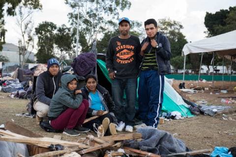 December 1, 2018 - Tijuana, Mexico - MIGRANTS MOVING SHELTER IN TIJUANA. Mexican officials move the migrants from Honduras from shelter close to the boarder to shelter furtherer away. Scenes of ghost town inside original shelter. Family in front of their temporary shelter Tijuana Mexico - ZUMAc109 20181201_zap_c109_011 Copyright: xRachelxCerettox