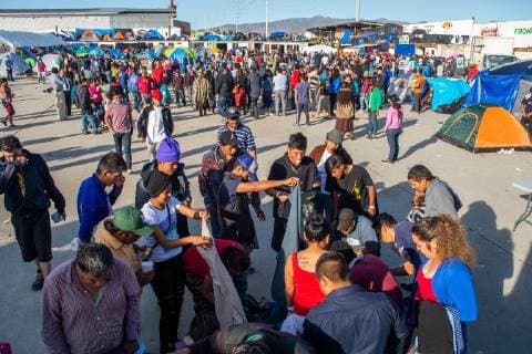December 2, 2018 - Aslyum seekers from the Migrant Caravan go through clothes donations at El Barretal, the new makeshift shelter in Tijuana,Mexico on December 2, 2018. El Barretal, a dance hall event space and located a few miles from the border, has been designated as the shelter for the Central Americans. .The number of migrants is over 1,000 and rising at the camp. - ZUMAs157 20181202_znp_s157_014 Copyright: xVitoxDixStefanox