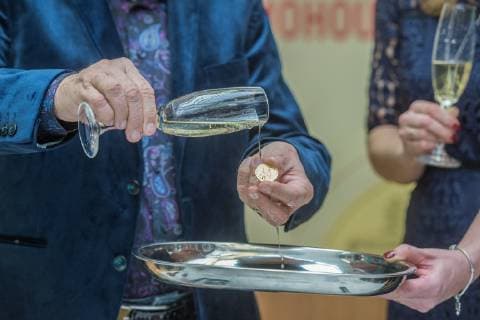 Czech famous singer Karel Gott (left) solemnly coined gold and silver medals with his own portrait for the series Slavici ve zlate (Nightingales in gold) in the Czech Mint, on December 5, 2018, in Jablonec nad Nisou, Czech Republic. On the photo Gott baptizing the gold medal. (CTKxPhoto RadekxPetrasek) CTKPhotoP201812050514701  PER 8