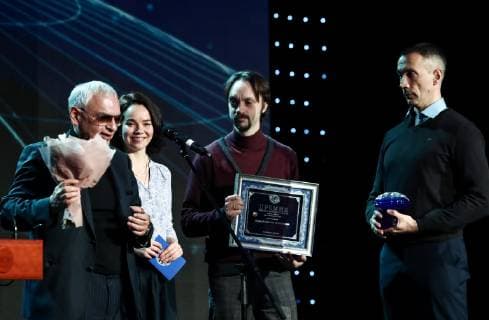 MOSCOW, RUSSIA - DECEMBER 7, 2018: Head of Lesfilm Studio Irina Zhuravleva (2nd L), film editor Vladislav Grishin (2nd R), and camera director Dmitry Shpilenok (R) receive a 2018 Russian Geographical Society Prize in the Best Medial Project category for their documentary film Kamchatka Bears: the Beginning of Life from Mosfilm general director, film director Karen Shakhnazarov (L) during the award ceremony at the State Kremlin Palace. Anton Novoderezhkin TASS  TS09A548