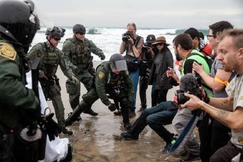A scuffle between border patrol agents and a demonstrator occurs at Border Field State Park in San Diego, California on December 10, 2018.  SD02018121048 ARIANAxDREHSLER