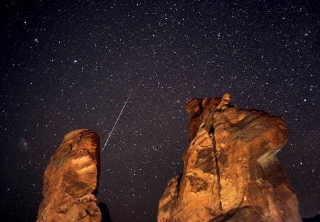 Dec. 14, 2018 - Las Vegas, Nevada, U.S. - A Geminid meteor streaks across the sky over one of the peaks of the Seven Sisters rock formation early December 14th in the Valley of Fire State Park near Las Vegas. The meteor display, known as the Geminid meteor shower because it appears to radiate from near the star Castor in the constellation Gemini, is thought to be the result of debris cast off from an asteroid-like object called 3200 Phaethon. The shower is visible every December. Las Vegas USA - ZUMAbk3_ 20181214_zaf_bk3_002 Copyright: xDavidxBeckerx