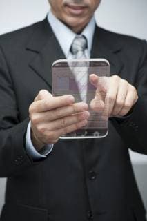 Businessman using advanced digital tablet to access stock market data, cropped  Copyright: MilenaxBoniek B54350925