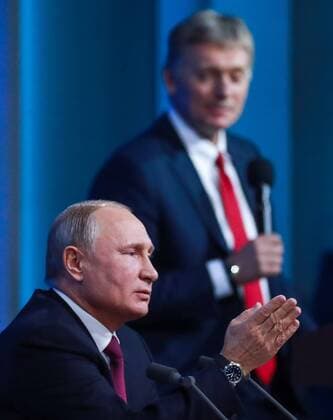 MOSCOW, RUSSIA â€“ DECEMBER 20, 2018: Russia s President Vladimir Putin (L) and his spokesman Dmitry Peskov at an annual end-of-year news conference at Moscow s World Trade Centre. Sergei Fadeichev TASS  TS09BD24