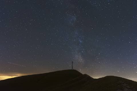 Italy, Marche, silhouette of summit cross on Monte Catria at night  LOMF00662