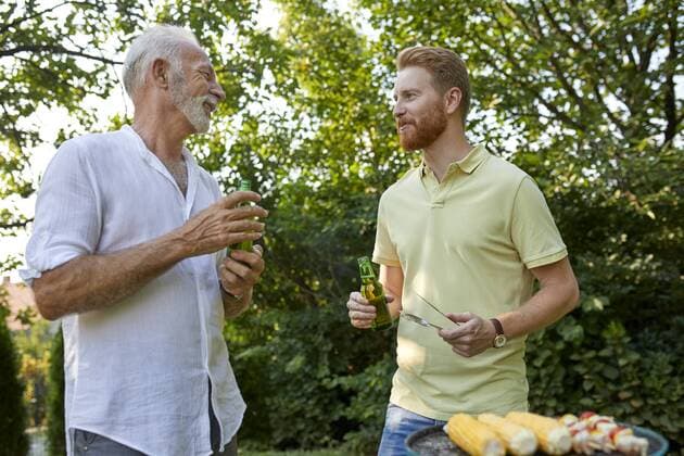 Senior father and adult son having a barbecue and talking in garden model released Symbolfoto property released  ZEDF01581