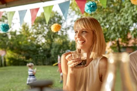 Happy woman drinking coffee on a garden party model released Symbolfoto property released  ZEDF01649