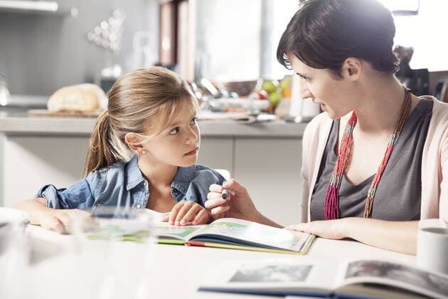 Mother and young daughter reading together  Copyright: SigridxOlsson B17572522